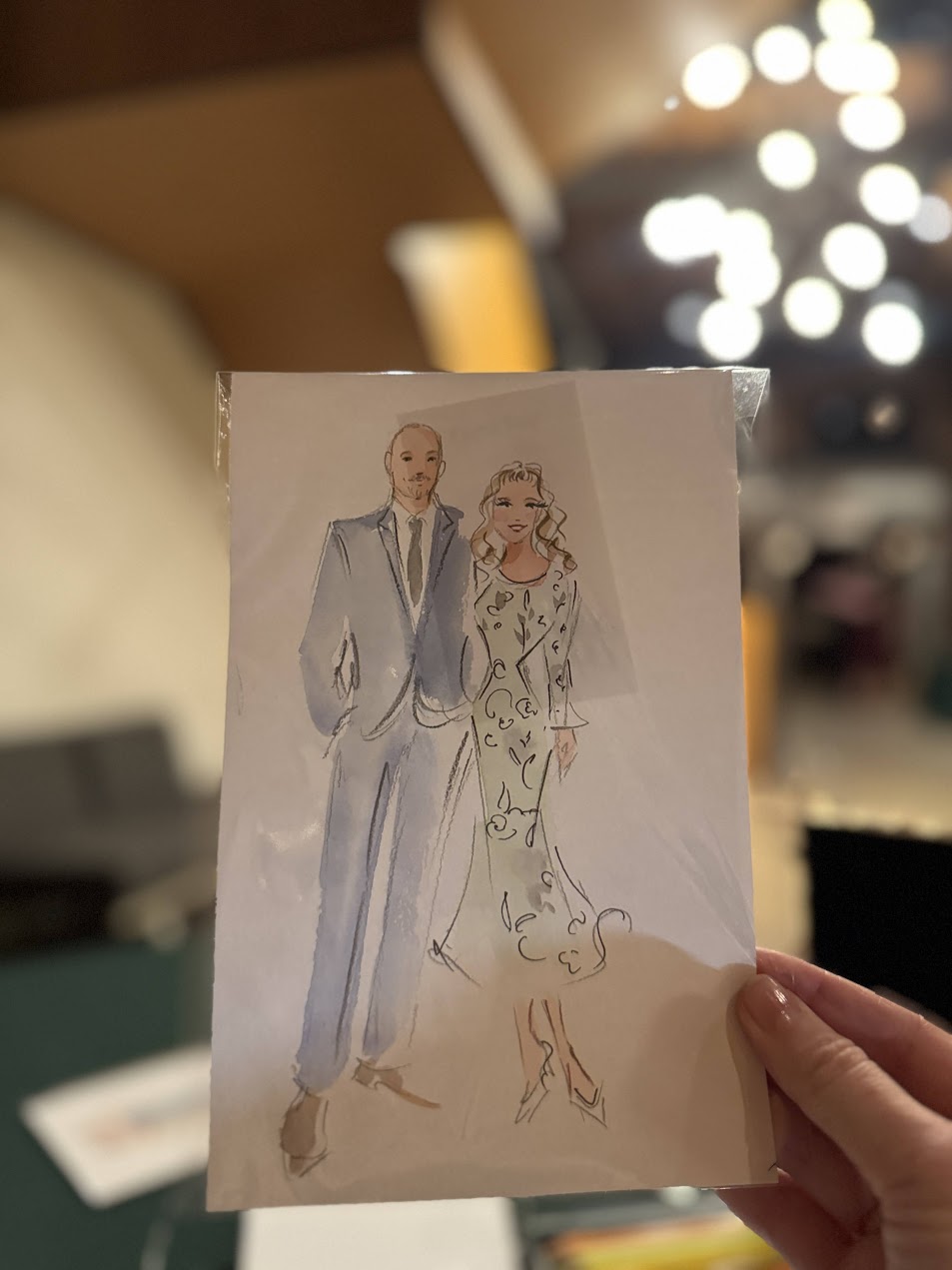 A finished couple portrait held inside a transparent protective sleeve